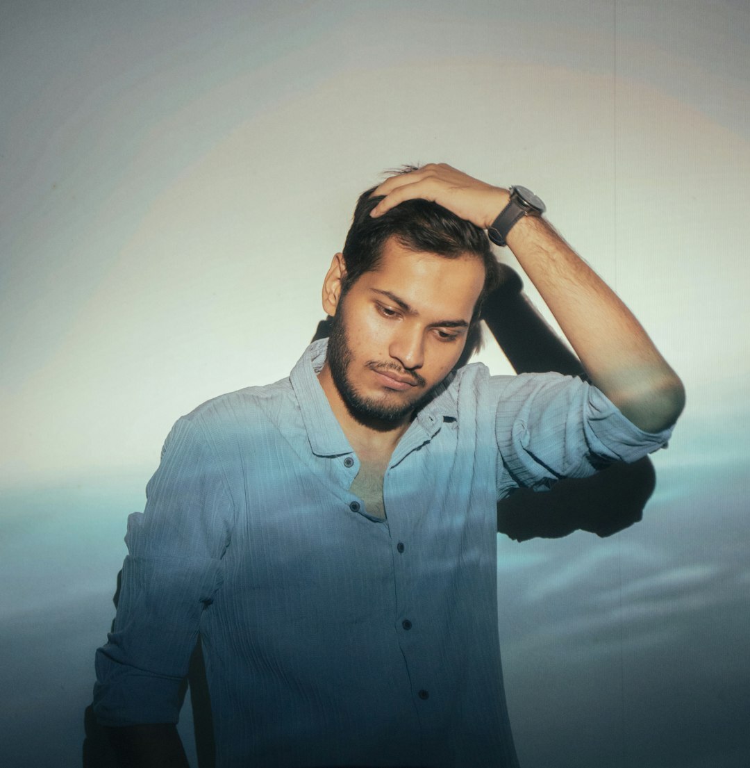 Professional man with light stubble in smart casual shirt